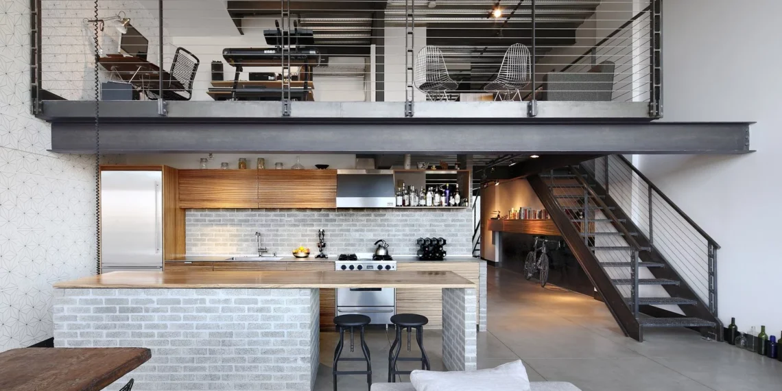 A furnished loft with stair bed chairs table and sofa -