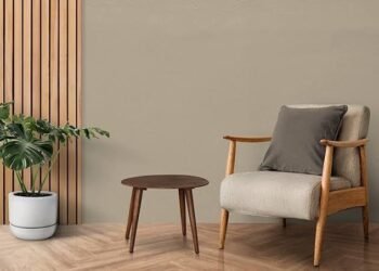 A sofa chair placed in the room with the table and plant-Durable Furniture