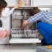 A men and women trying to fix a broken appliance in the home - Appliance Repairs