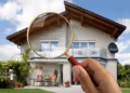 A guy Inspecting the house through a magnifying glass