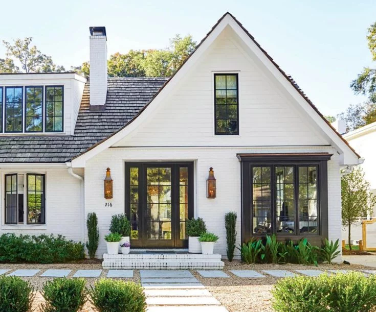 White Brick House With A Clear Black Trim On The Top