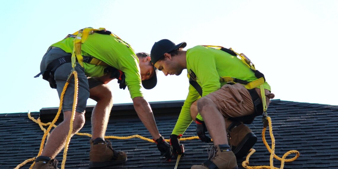 Two men fixing the roof for a better Lifespan of Your Roof