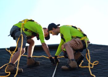 Two men fixing the roof for a better Lifespan of Your Roof