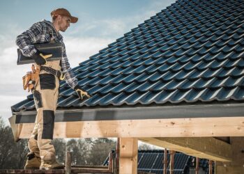 A roofing contractor inspecting the roof