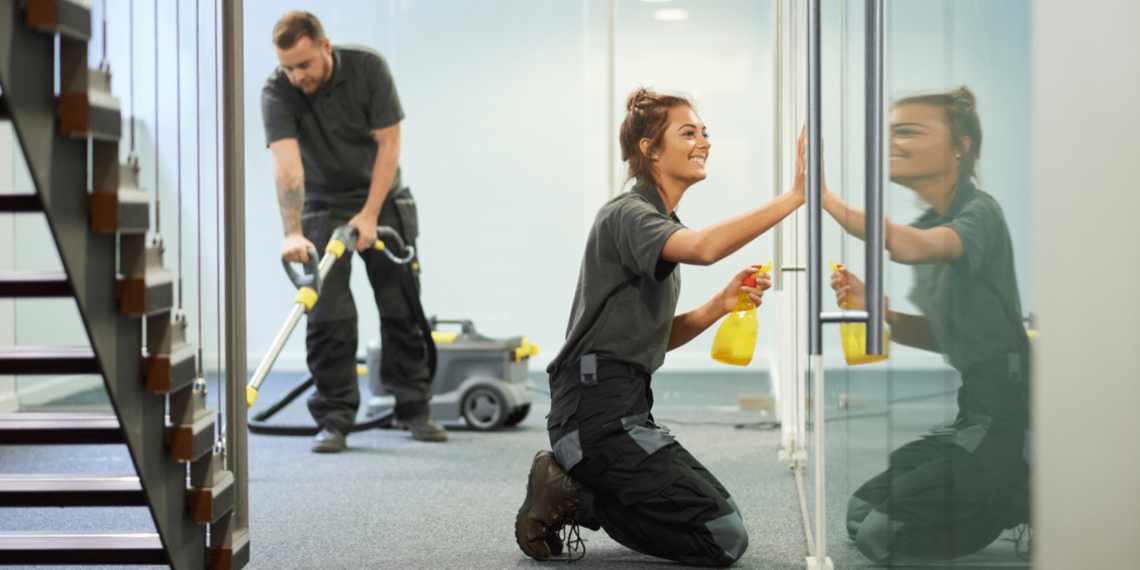 A guy and a girl cleaning the building