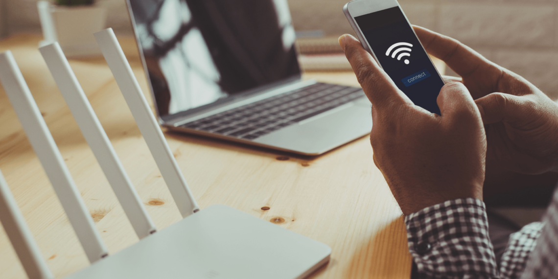 A person setting up a home WiFi router