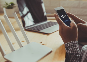 A person setting up a home WiFi router