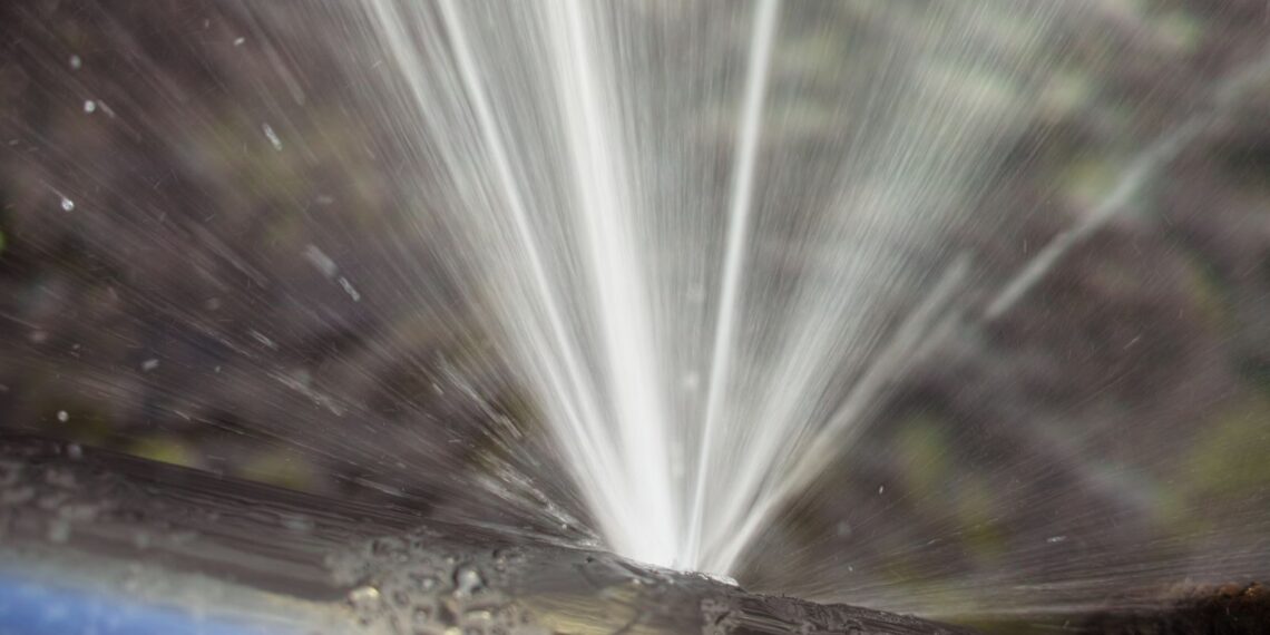 Water leaks from a water pipe indicating water wastage