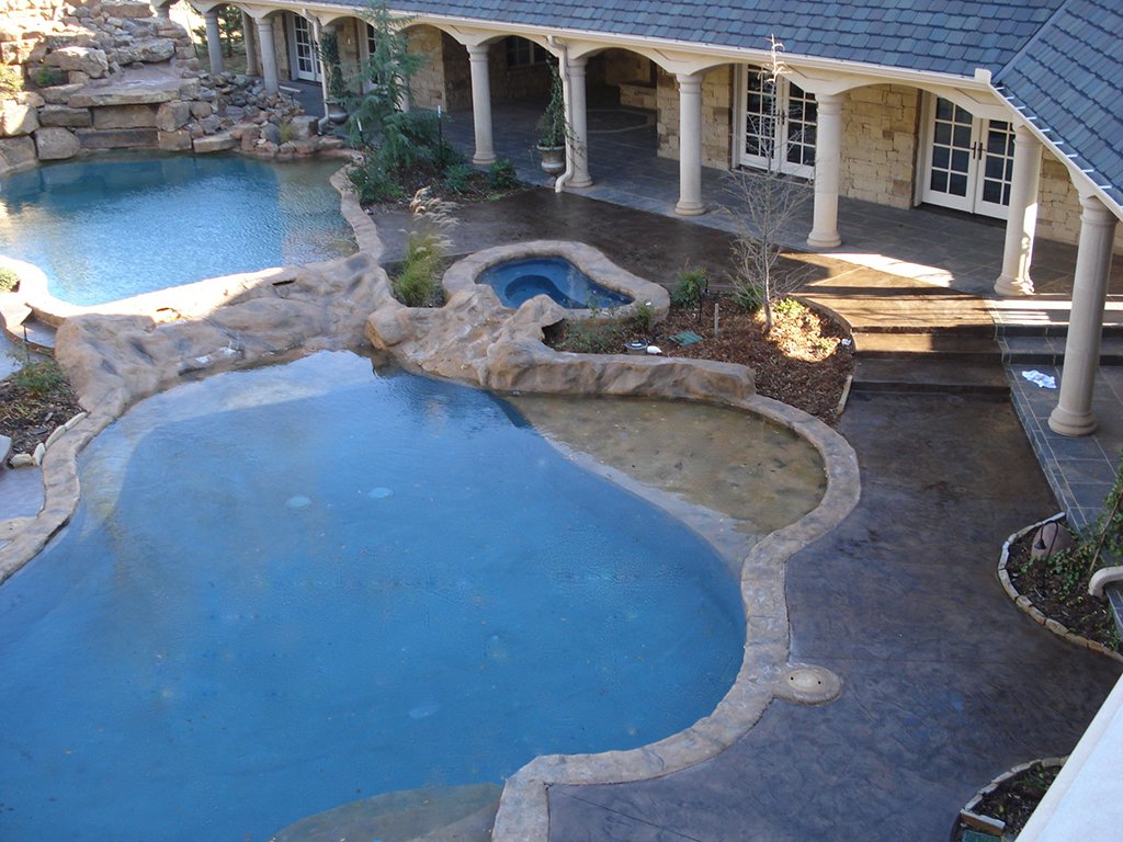 Dynamic stains and stamped concrete motifs pool deck