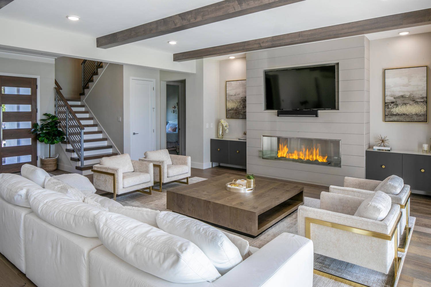 Modern Living Room with center table surrounded by furniture and a firepit in the wall