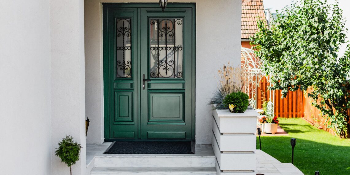 A white house with green colored front door
