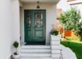 A white house with green colored front door