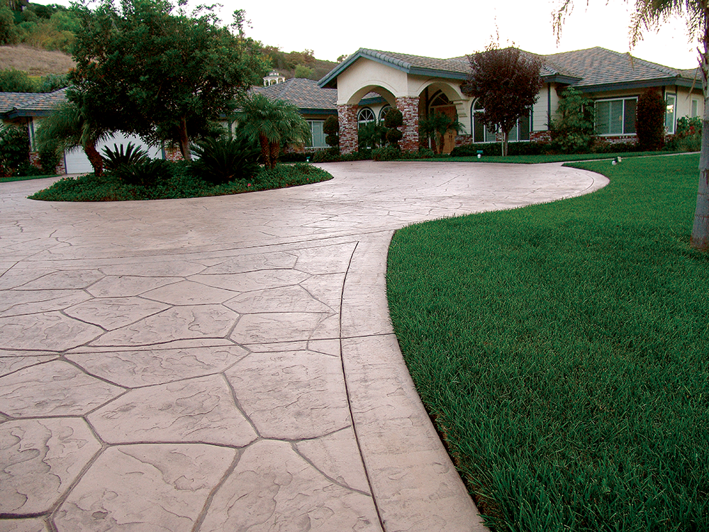 The random stone pattern for concrete and grass driveway