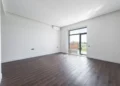 Empty room with balcony and parquet floor