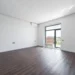 Empty room with balcony and parquet floor