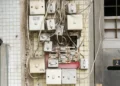 several assorted power switches mounted on white wall - Circuit Breaker
