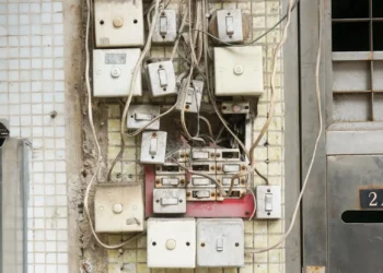several assorted power switches mounted on white wall - Circuit Breaker